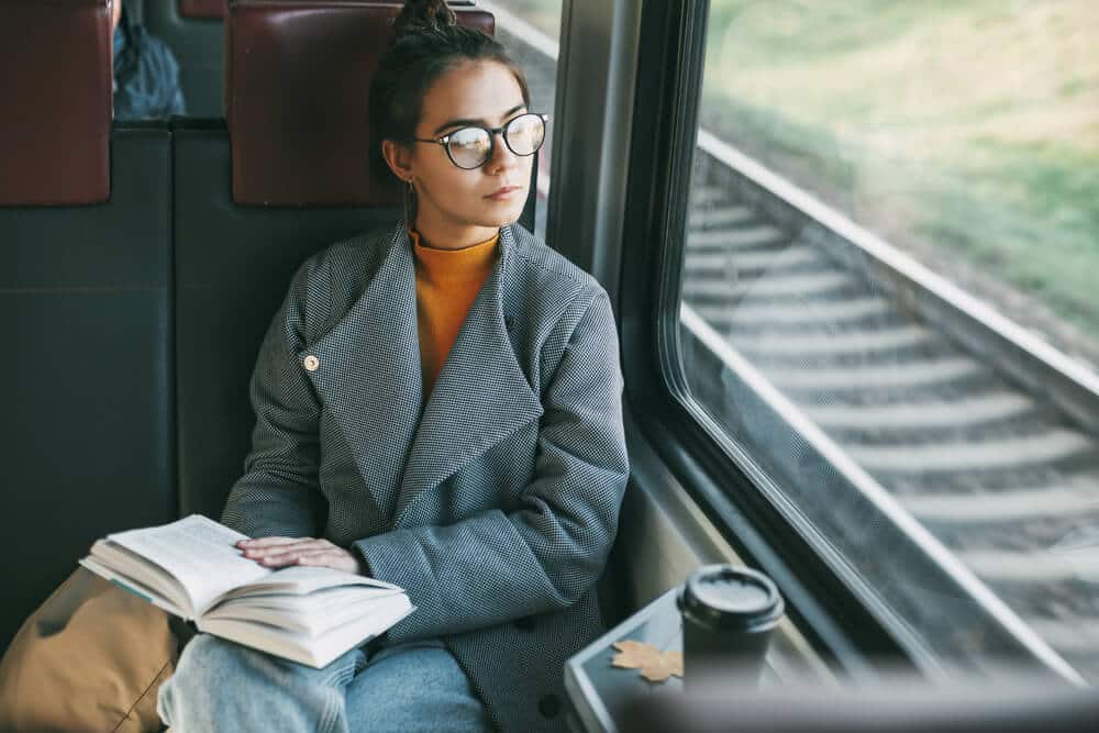 Young woman reading on train | www.phillyaptrentals.com 