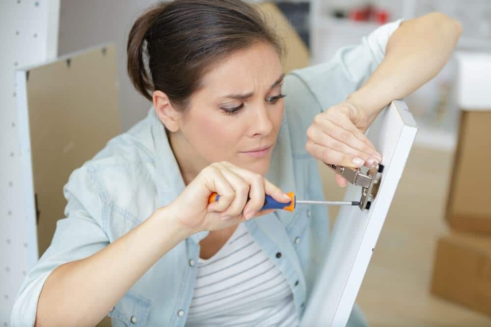 Woman Installing Closet Organizer | www.phillyaptrentals.com 