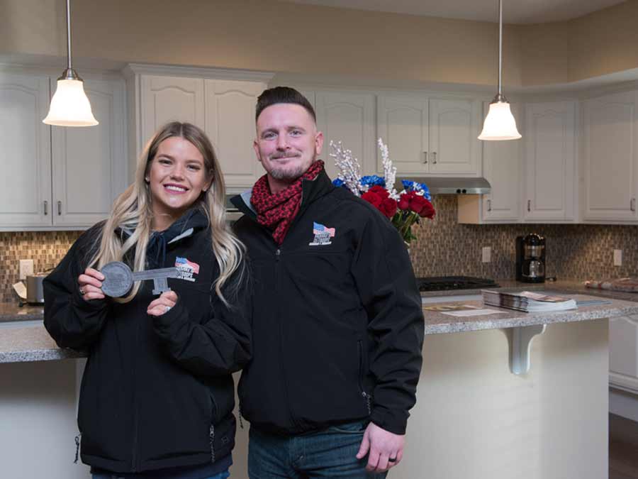 Young veteran couple standing in their new kitchen