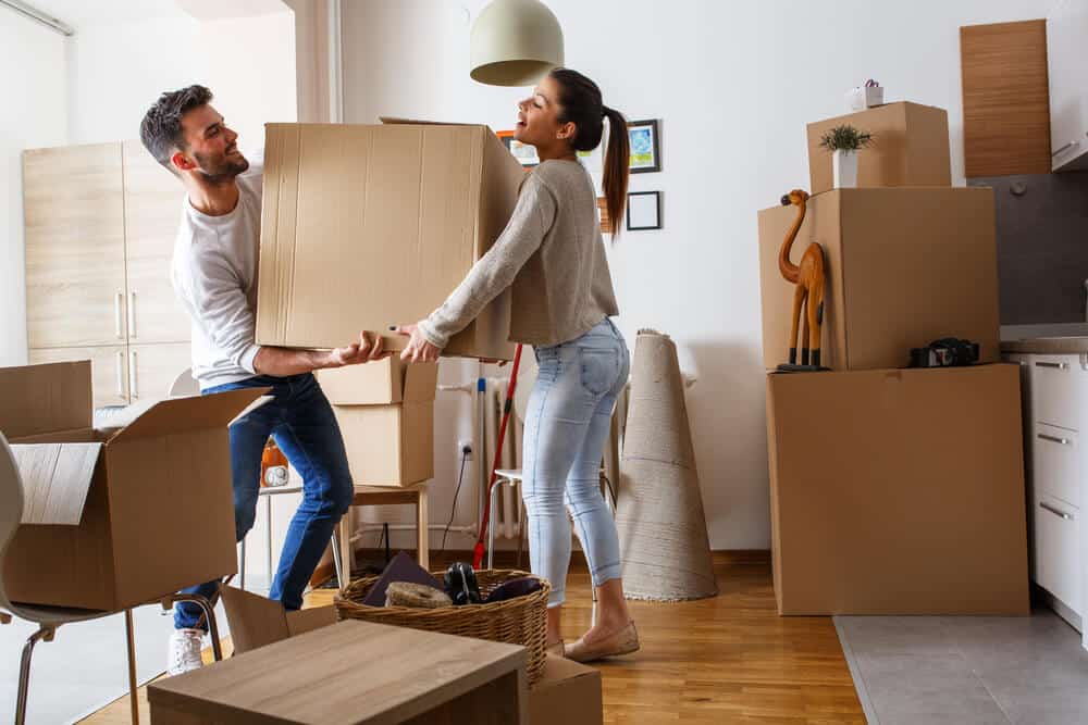 Couple Moving Boxes Into Home | www.phillyaptrentals.com