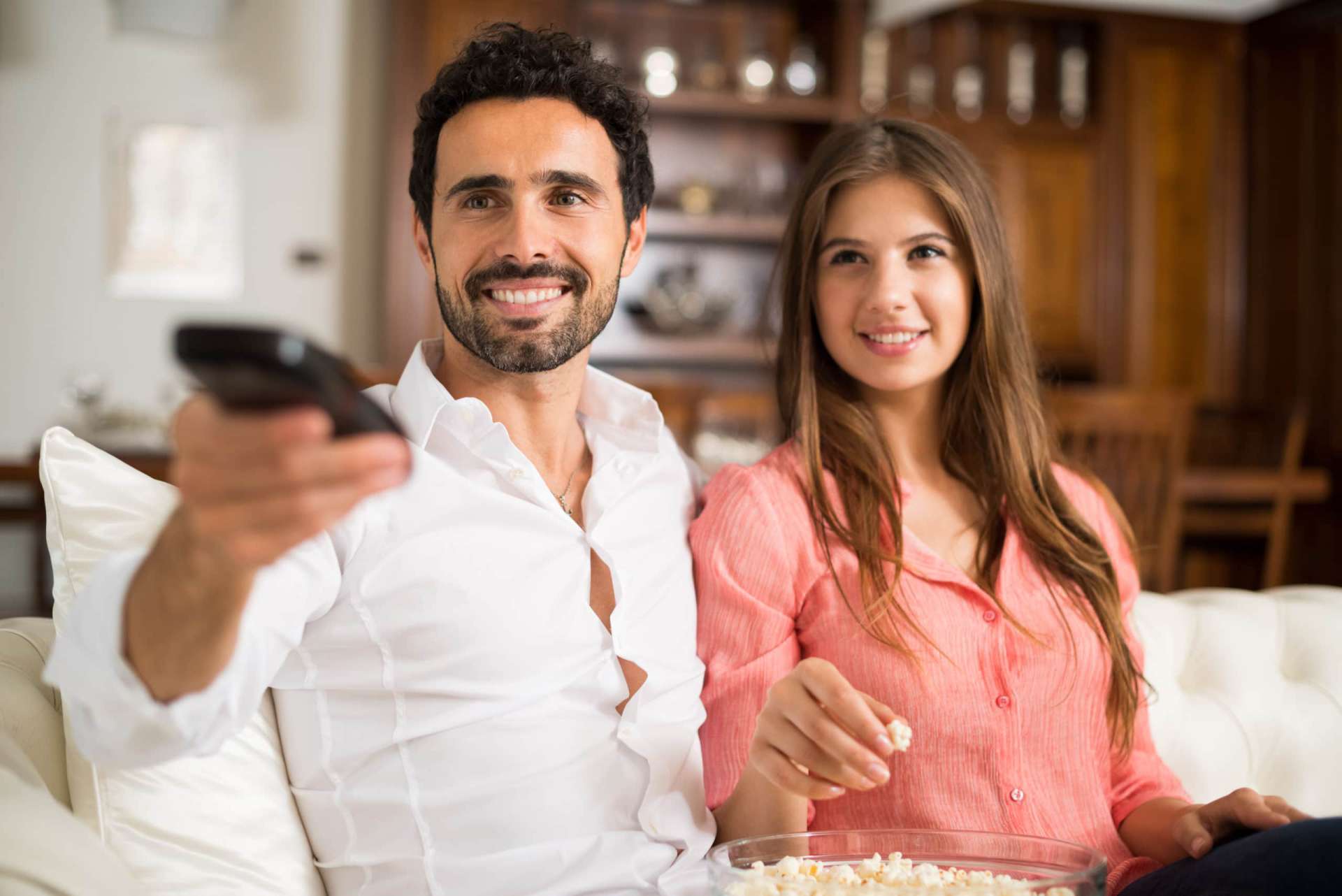 couple watching cable tv in their apartment