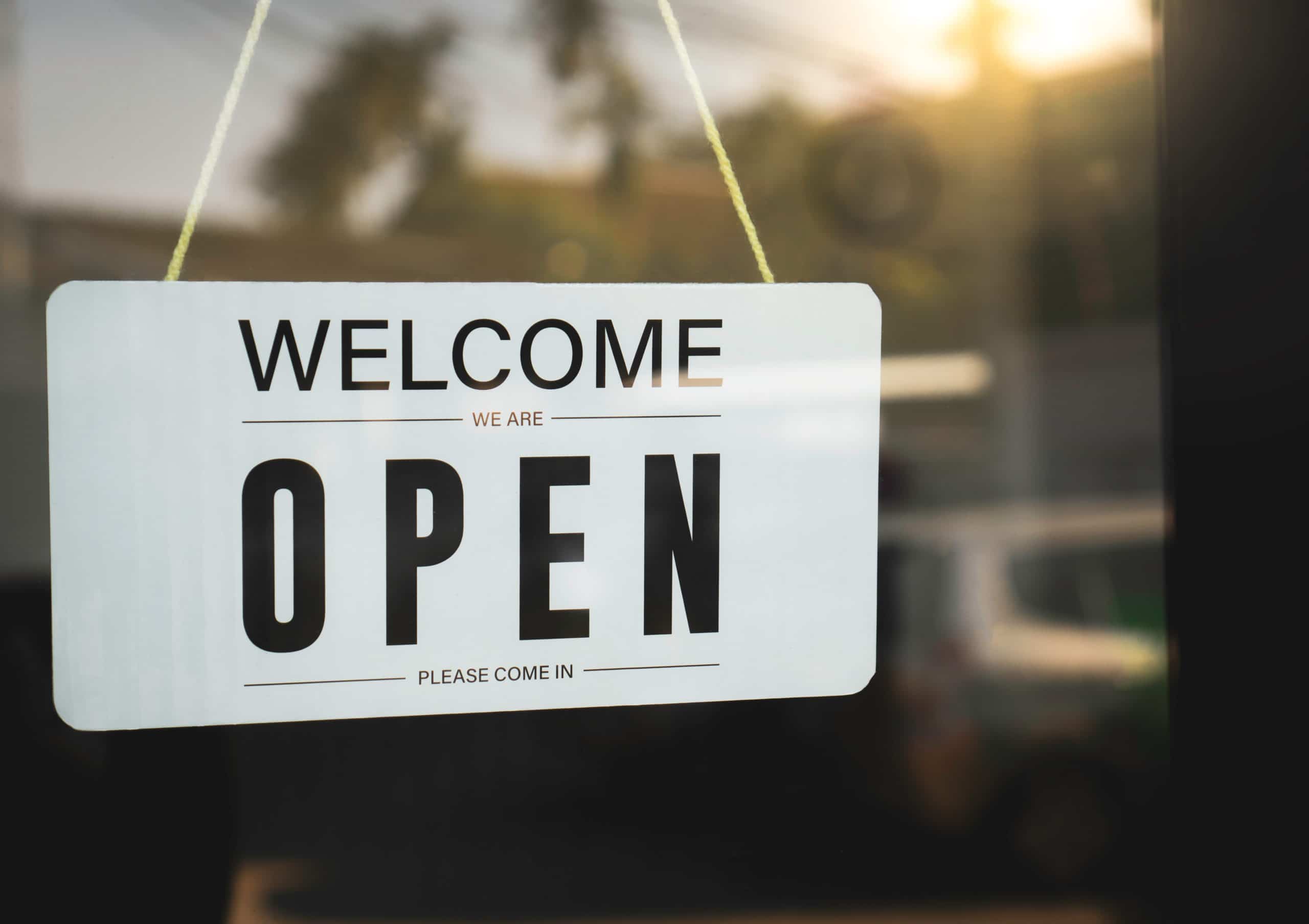 Welcome We're Open Sign representing whether rental offices are open or closed during the pandemic