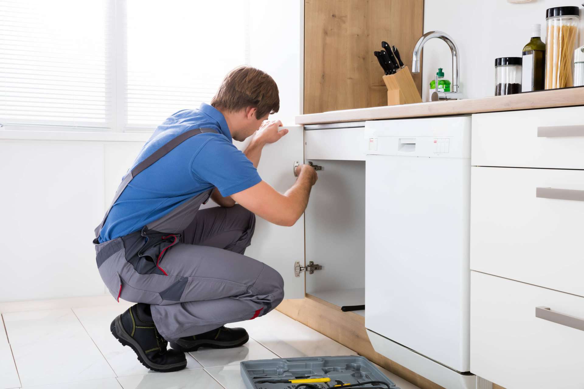 What Questions To Ask at an Apartment Showing | Man Servicing Sink Leak | www.phillyaptrentals.com