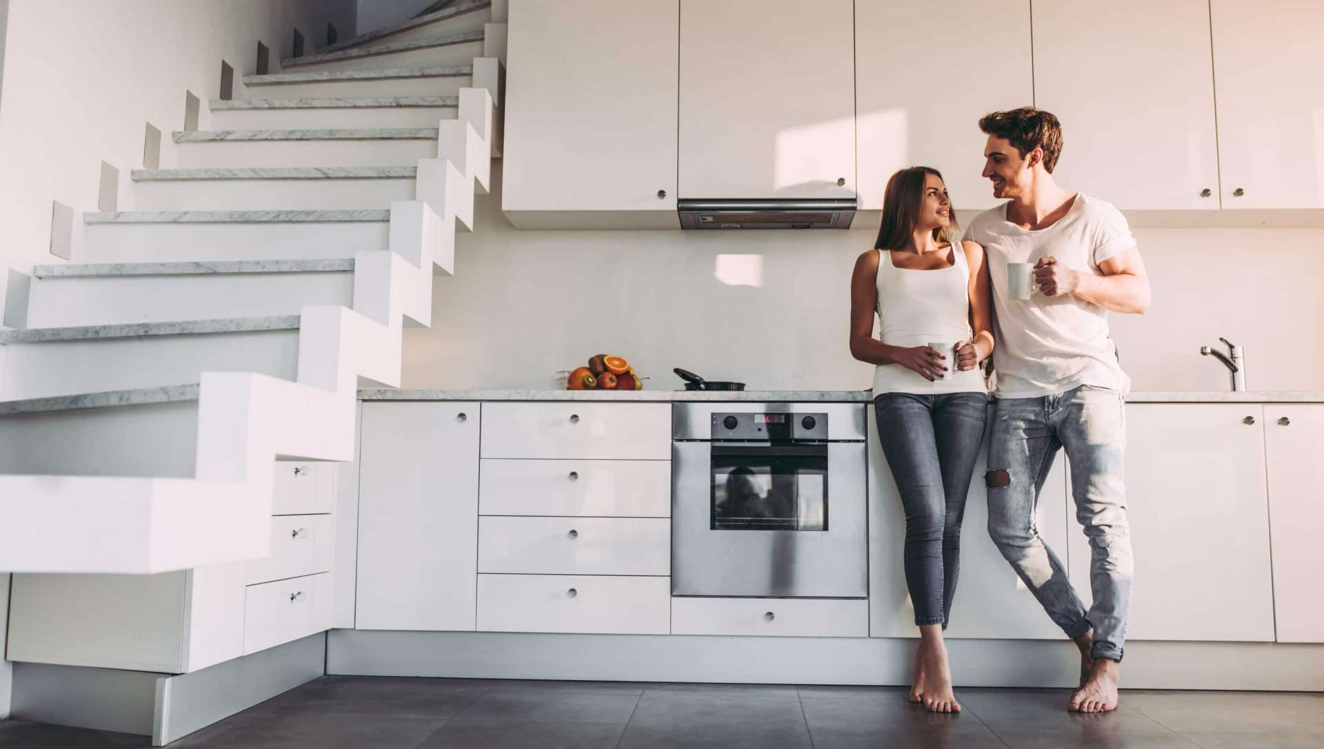 apartment with two floors, man and woman talking in kitchen
