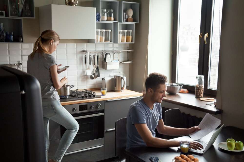 Is a One-Bedroom Right Apartment for a Couple? | Couple Working From Home in Kitchen | www.phillyaptrentals.com 