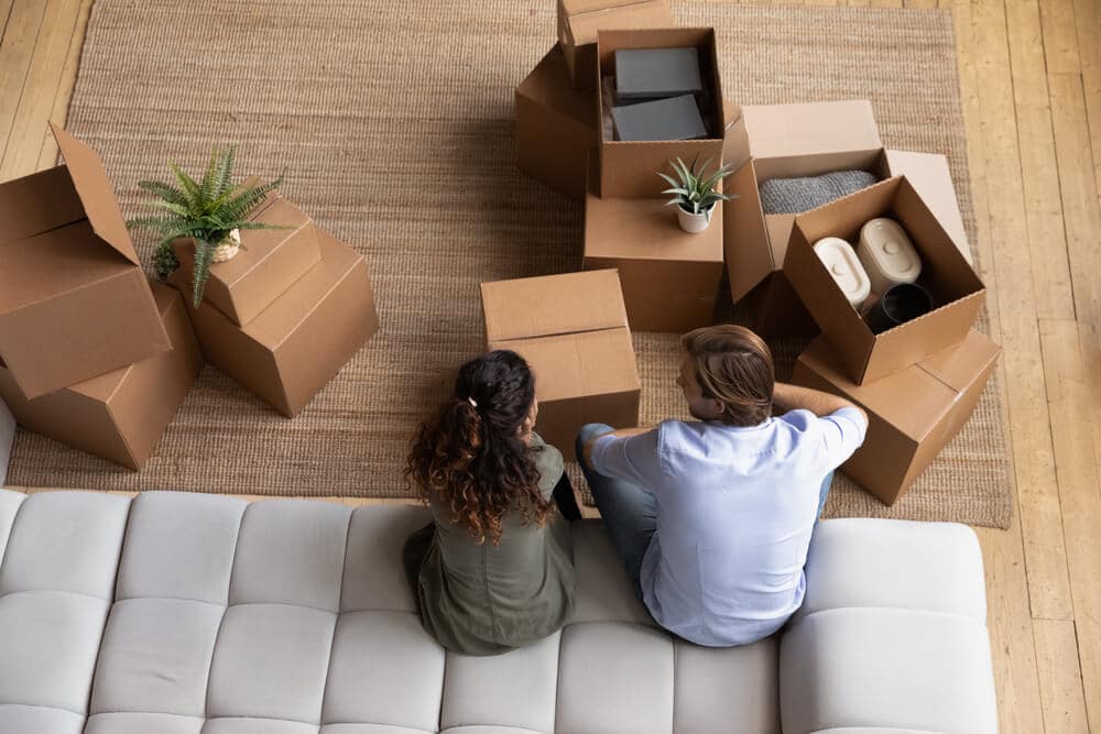 Disadvantages of Renting from a Private Landlord | Couple in New Home with Boxes | www.phillyaptrentals.com
