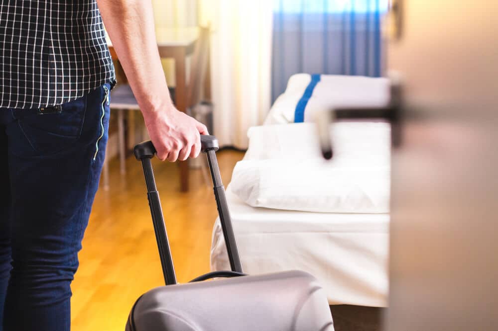 Can I Rent a Room In My Apartment | Man With Suitcase at Door | www.phillyaptrentals.com