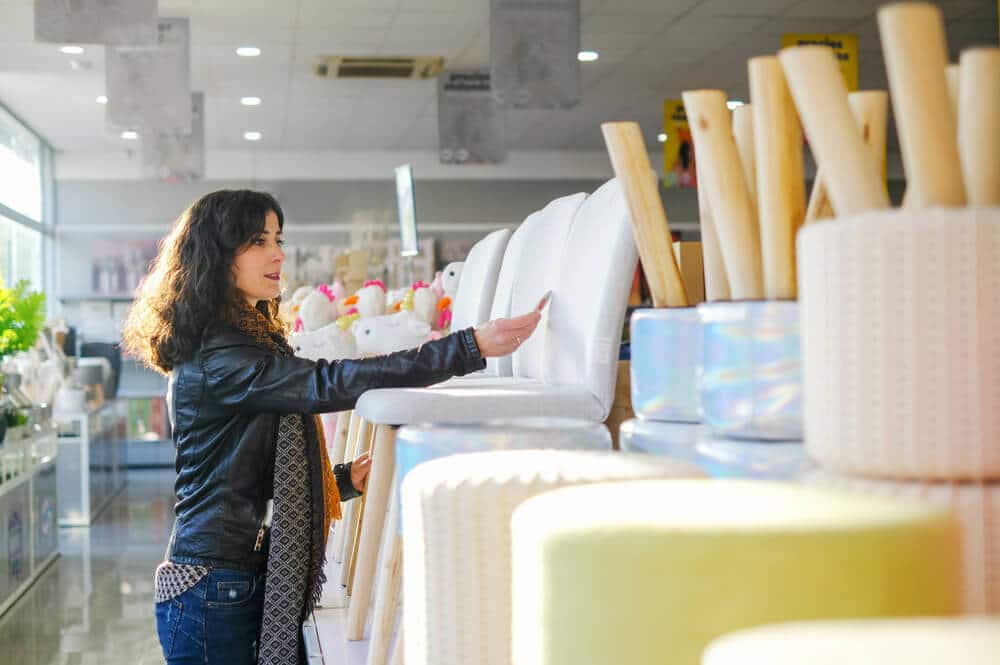 Woman Checking Prices When Furniture Shopping For Her Apartment | www.phillyaptrentals.com